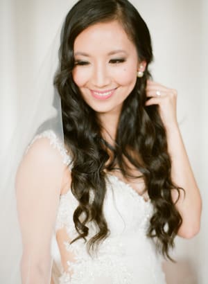Bride with softly styled, personalised bridal hair featuring natural movement and shine